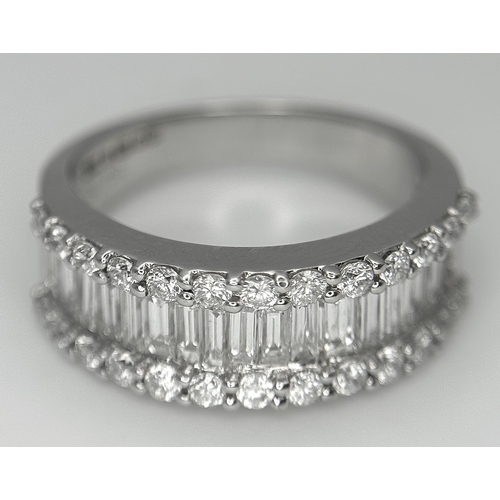 179 - An 18K White Gold Diamond Half Eternity Ring. c. 2.5ctw of baguette and round brilliant cut diamonds... 