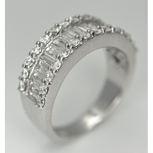 179 - An 18K White Gold Diamond Half Eternity Ring. c. 2.5ctw of baguette and round brilliant cut diamonds... 