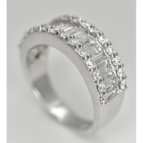 179 - An 18K White Gold Diamond Half Eternity Ring. c. 2.5ctw of baguette and round brilliant cut diamonds... 