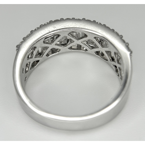 179 - An 18K White Gold Diamond Half Eternity Ring. c. 2.5ctw of baguette and round brilliant cut diamonds... 