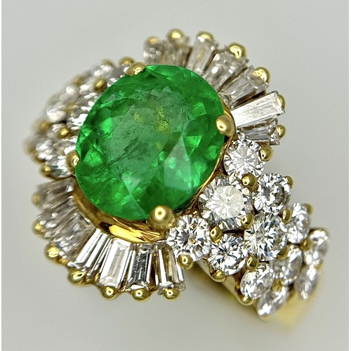 79 - An 18K Yellow Gold Emerald and Diamond Ring. A 2ct central oval cut Brazilian emerald is surrounded ... 
