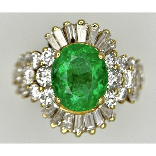79 - An 18K Yellow Gold Emerald and Diamond Ring. A 2ct central oval cut Brazilian emerald is surrounded ... 