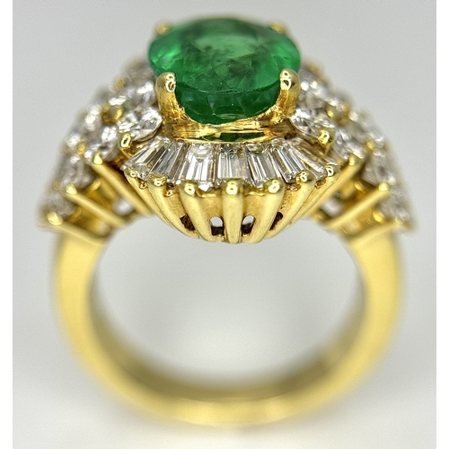 79 - An 18K Yellow Gold Emerald and Diamond Ring. A 2ct central oval cut Brazilian emerald is surrounded ... 