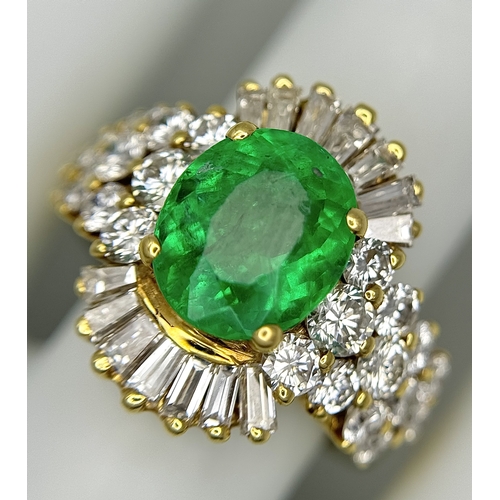 79 - An 18K Yellow Gold Emerald and Diamond Ring. A 2ct central oval cut Brazilian emerald is surrounded ... 