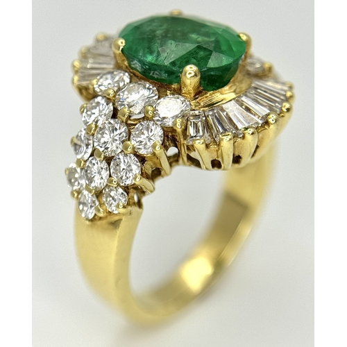 79 - An 18K Yellow Gold Emerald and Diamond Ring. A 2ct central oval cut Brazilian emerald is surrounded ... 
