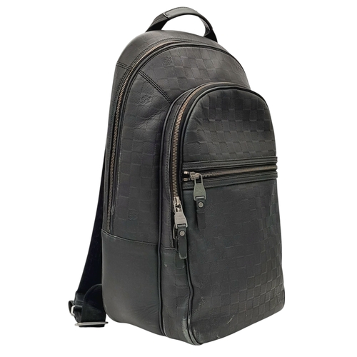174 - A Louis Vuitton Black Damier Michael Backpack. Leather and textile exterior with silver-toned hardwa... 