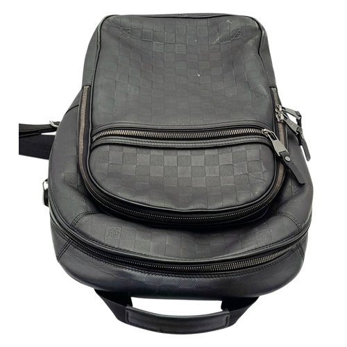174 - A Louis Vuitton Black Damier Michael Backpack. Leather and textile exterior with silver-toned hardwa... 