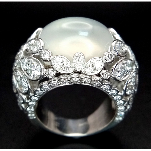 121 - A Ritz of London 18K White Gold, Diamond and Moonstone Dome Dress Ring. An 8ct hypnotising oval cut ... 