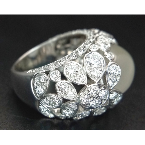 121 - A Ritz of London 18K White Gold, Diamond and Moonstone Dome Dress Ring. An 8ct hypnotising oval cut ... 