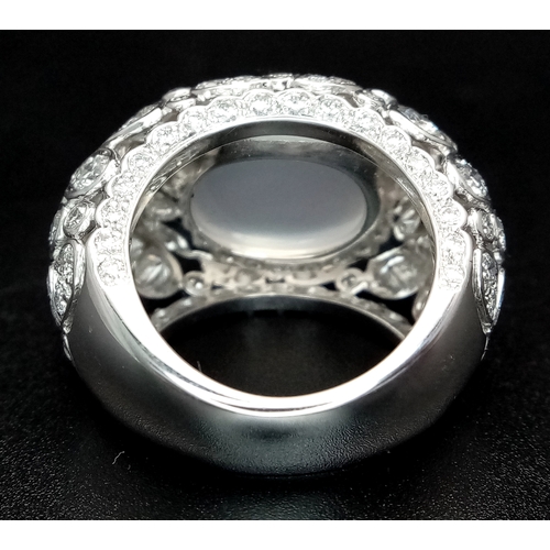 121 - A Ritz of London 18K White Gold, Diamond and Moonstone Dome Dress Ring. An 8ct hypnotising oval cut ... 
