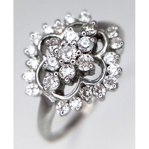 61 - AN 18K WHITE GOLD DIAMOND CLUSTER RING. 0.20CTW. 3.4G. SIZE N. REF-9808.