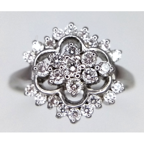 61 - AN 18K WHITE GOLD DIAMOND CLUSTER RING. 0.20CTW. 3.4G. SIZE N. REF-9808.