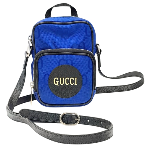 773 - A Gucci Blue GG Nylon Crossbody Bag. Blue GG textile exterior with silver-tone hardware, a front zip... 