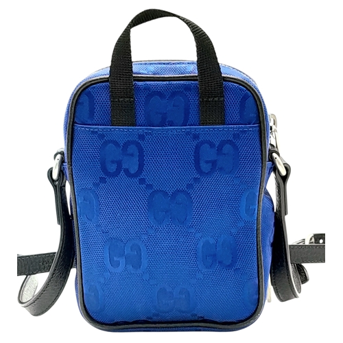 773 - A Gucci Blue GG Nylon Crossbody Bag. Blue GG textile exterior with silver-tone hardware, a front zip... 