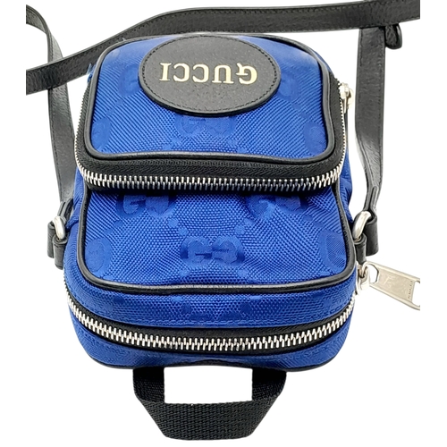 773 - A Gucci Blue GG Nylon Crossbody Bag. Blue GG textile exterior with silver-tone hardware, a front zip... 