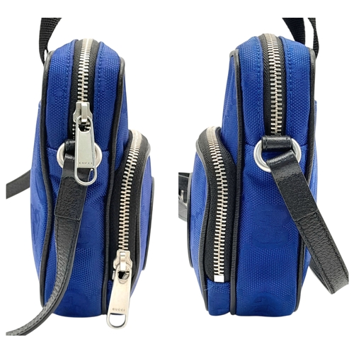 773 - A Gucci Blue GG Nylon Crossbody Bag. Blue GG textile exterior with silver-tone hardware, a front zip... 