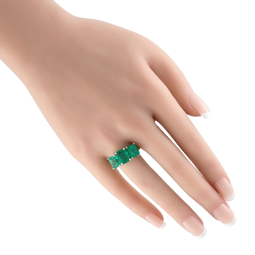 149 - A stunning Platinum 8.0ctw Colombian Emerald Three-Stone Ring. This platinum ring features three Col... 