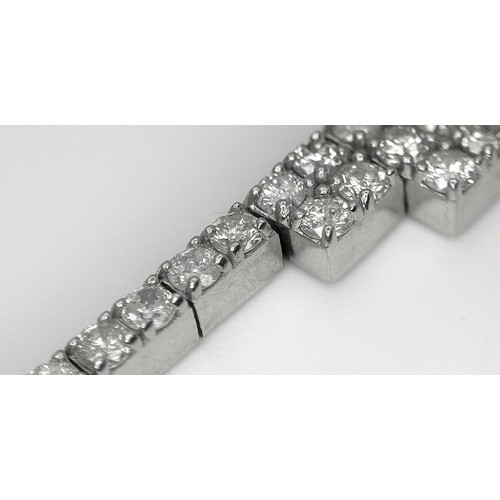 135 - A 14K White Gold Diamond Bracelet. 3.5ctw of round brilliant cut diamonds in a Tetrus-esque design. ... 