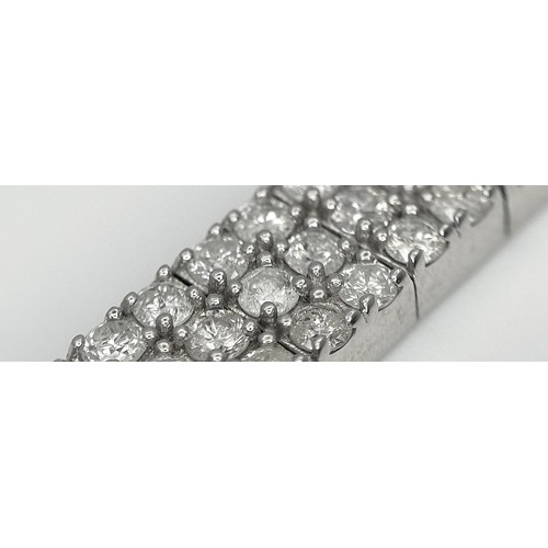 135 - A 14K White Gold Diamond Bracelet. 3.5ctw of round brilliant cut diamonds in a Tetrus-esque design. ... 