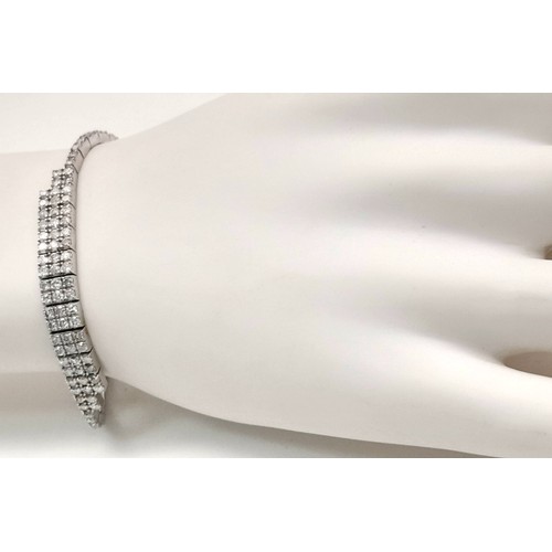 135 - A 14K White Gold Diamond Bracelet. 3.5ctw of round brilliant cut diamonds in a Tetrus-esque design. ... 