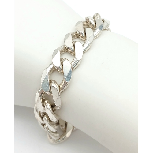 747 - A STERLING SILVER HEAVY CURB BRACELET. 24.5CM LENGTH. 58.1G. 8541-1.