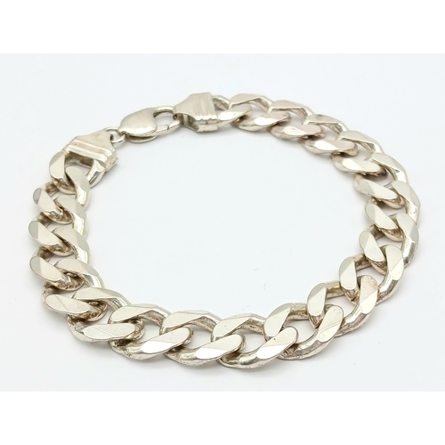 747 - A STERLING SILVER HEAVY CURB BRACELET. 24.5CM LENGTH. 58.1G. 8541-1.