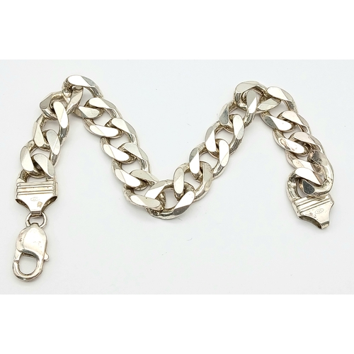 747 - A STERLING SILVER HEAVY CURB BRACELET. 24.5CM LENGTH. 58.1G. 8541-1.