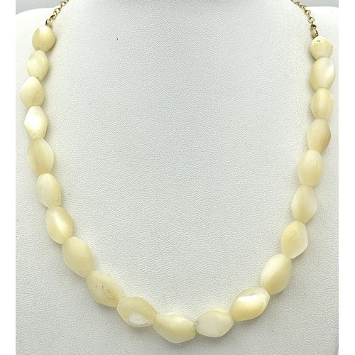 214 - Ivory Coloured Iridescent Beads with a 14K Gold Filled Extender Chain. Comes with a COA. 44cm.