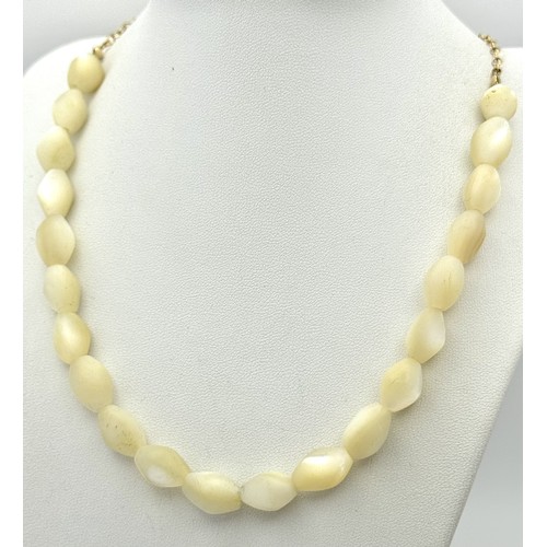 214 - Ivory Coloured Iridescent Beads with a 14K Gold Filled Extender Chain. Comes with a COA. 44cm.