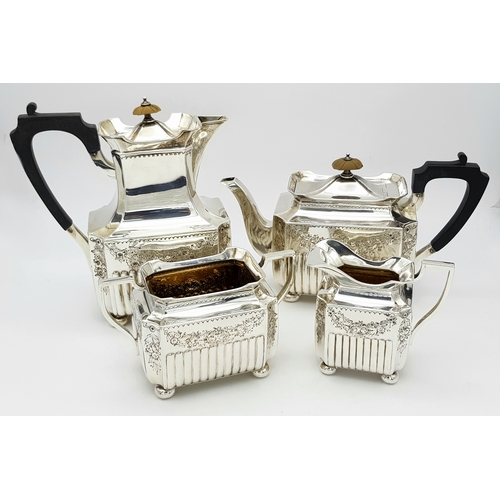 A Wonderful, Antique Victorian Tea and Coffee Sterling Silver Set. A square shaped body set with ornate floral and scrollwork designs. Bakelite handles and wood finials. Hallmarks for Birmingham 1890. Makers mark of Elkington and Co. Teapot - 25 x 15cm. Coffee pot 19 x 21cm. Sugar bowl - 12 x 17cm. Creamer jug 11 x 11cm. In overall good condition but please see pictures for finer details. 1870g total weight.