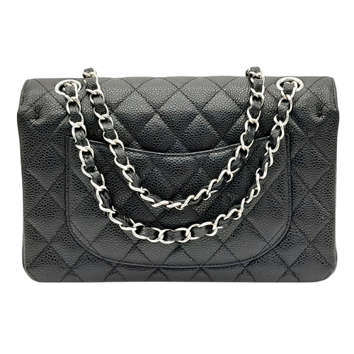 690 - A Chanel Black Caviar Classic Double Flap Bag. Black caviar leather exterior with silver-tone hardwa... 