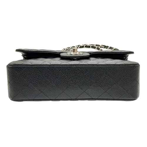 690 - A Chanel Black Caviar Classic Double Flap Bag. Black caviar leather exterior with silver-tone hardwa... 
