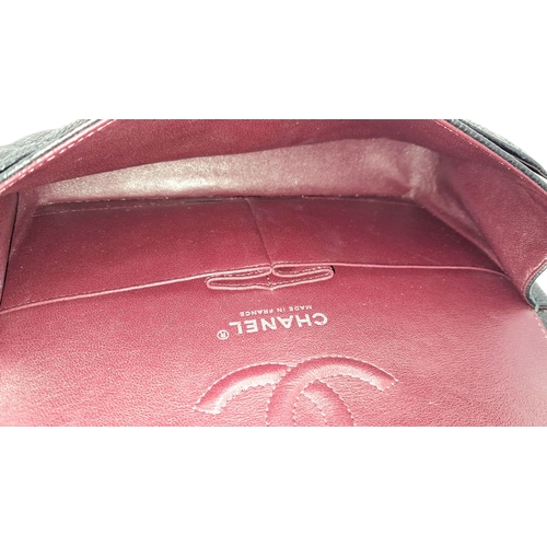 690 - A Chanel Black Caviar Classic Double Flap Bag. Black caviar leather exterior with silver-tone hardwa... 