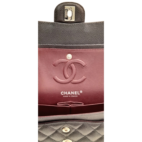 690 - A Chanel Black Caviar Classic Double Flap Bag. Black caviar leather exterior with silver-tone hardwa... 