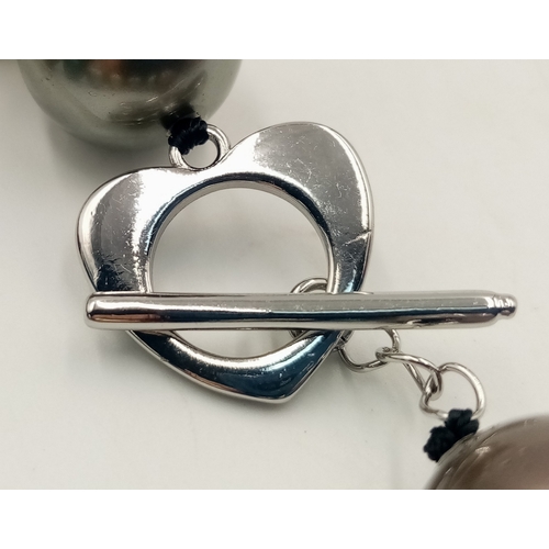 12 - A Multi-Colour South Sea Shell Pearl Necklace. 14mm beads. 42cm necklace length.