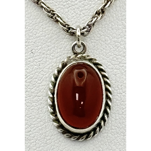 4 - A Sterling Silver and Carnelian Pendant on a 925 Silver Chain. 2cm and 44cm. 7.75g.