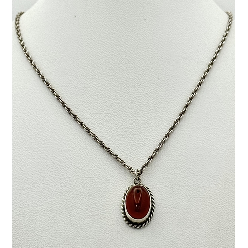 4 - A Sterling Silver and Carnelian Pendant on a 925 Silver Chain. 2cm and 44cm. 7.75g.