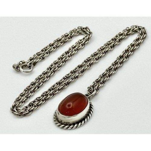 4 - A Sterling Silver and Carnelian Pendant on a 925 Silver Chain. 2cm and 44cm. 7.75g.