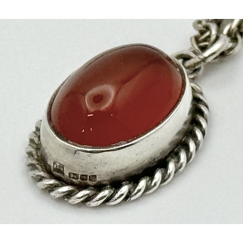 4 - A Sterling Silver and Carnelian Pendant on a 925 Silver Chain. 2cm and 44cm. 7.75g.