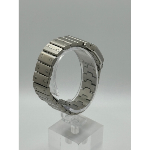 101 - A Cartier 1565 Stainless Steel Santos Watch, 24mm case white dial and Roman numerals. Year 2009, com... 