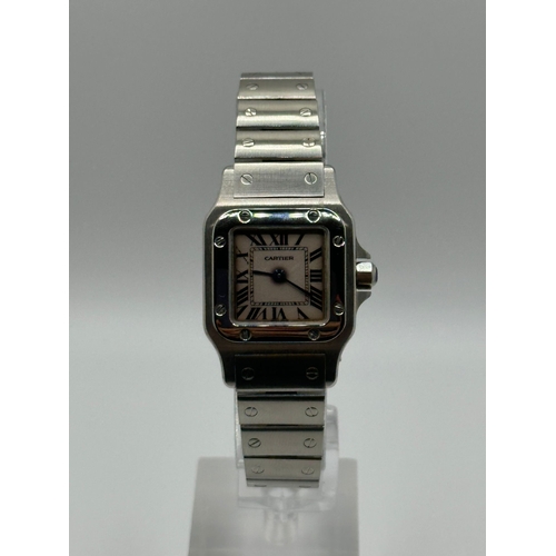 101 - A Cartier 1565 Stainless Steel Santos Watch, 24mm case white dial and Roman numerals. Year 2009, com... 
