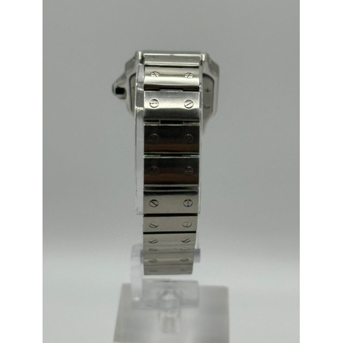 101 - A Cartier 1565 Stainless Steel Santos Watch, 24mm case white dial and Roman numerals. Year 2009, com... 