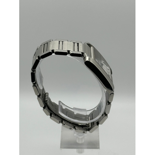 72 - A Cartier 2302  Stainless Steel Tank Watch. Year 2009, 28mm case with date box, comes with papers. I... 