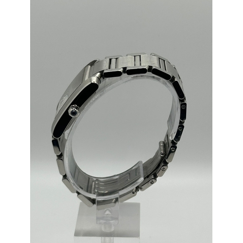 72 - A Cartier 2302  Stainless Steel Tank Watch. Year 2009, 28mm case with date box, comes with papers. I... 