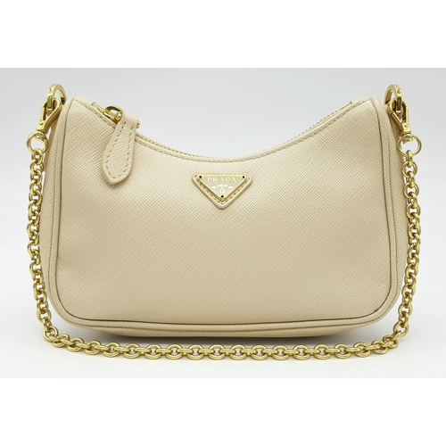 104 - A Prada Mini Re-Edition Saffiano Cream Leather Handbag. Gold-tone hardware. Comes with a certificate... 