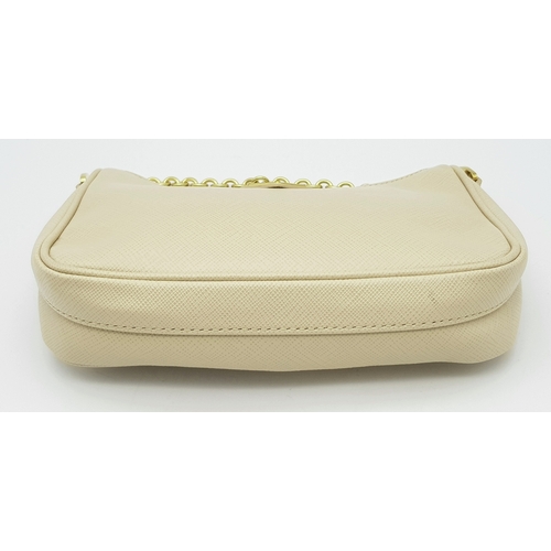 104 - A Prada Mini Re-Edition Saffiano Cream Leather Handbag. Gold-tone hardware. Comes with a certificate... 
