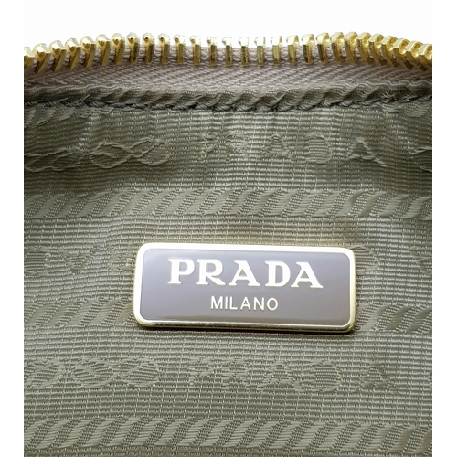 104 - A Prada Mini Re-Edition Saffiano Cream Leather Handbag. Gold-tone hardware. Comes with a certificate... 