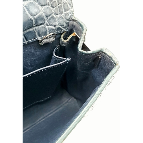 90 - An Asprey Blue Alligator Leather Handbag. Silver toned hardware. Shoulder strap. Blue leather interi... 