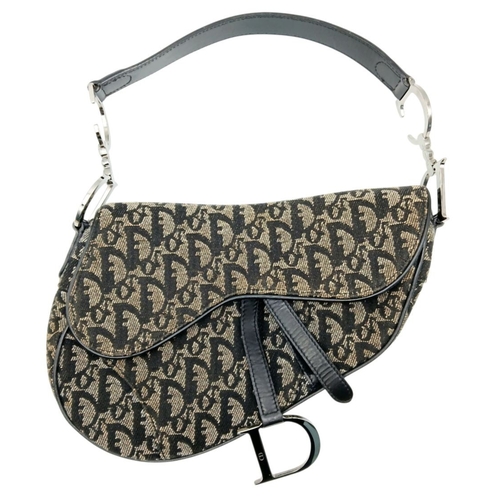 83 - A Christian Dior Saddle Canvas Bag. Black and cream  exterior with Dior monogram decoration througho... 