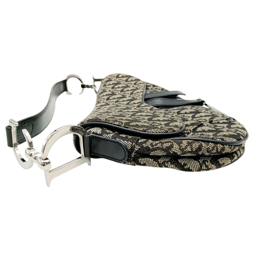 83 - A Christian Dior Saddle Canvas Bag. Black and cream  exterior with Dior monogram decoration througho... 